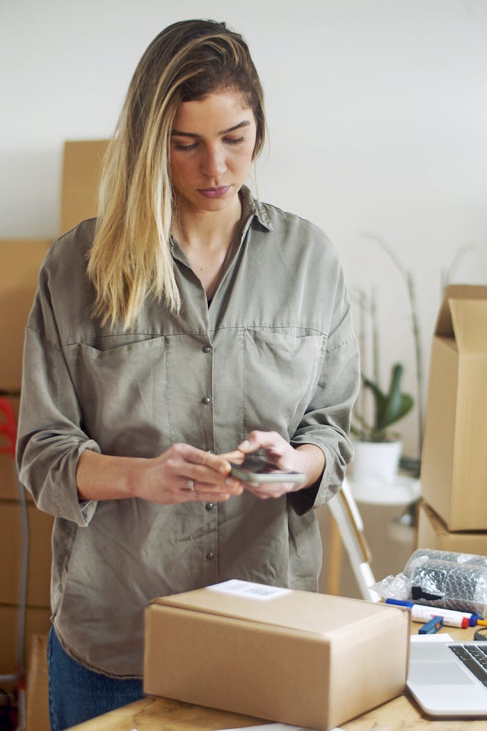 Woman in Gray Button Up Long Sleeve Shirt Holding Smartphone